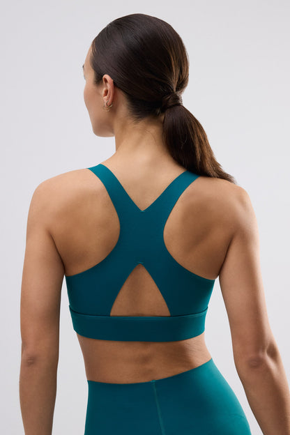 Sujetador deportivo compressive detalle abertura sujeción media verde