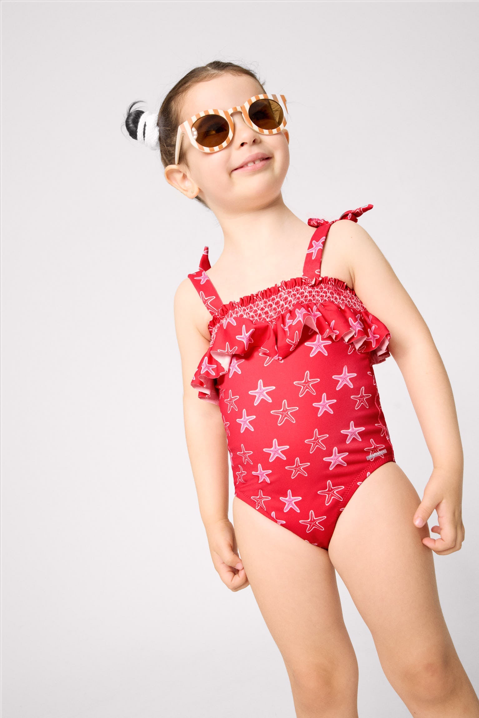 Bañador niña detalle volante estampado estrellas marinas
